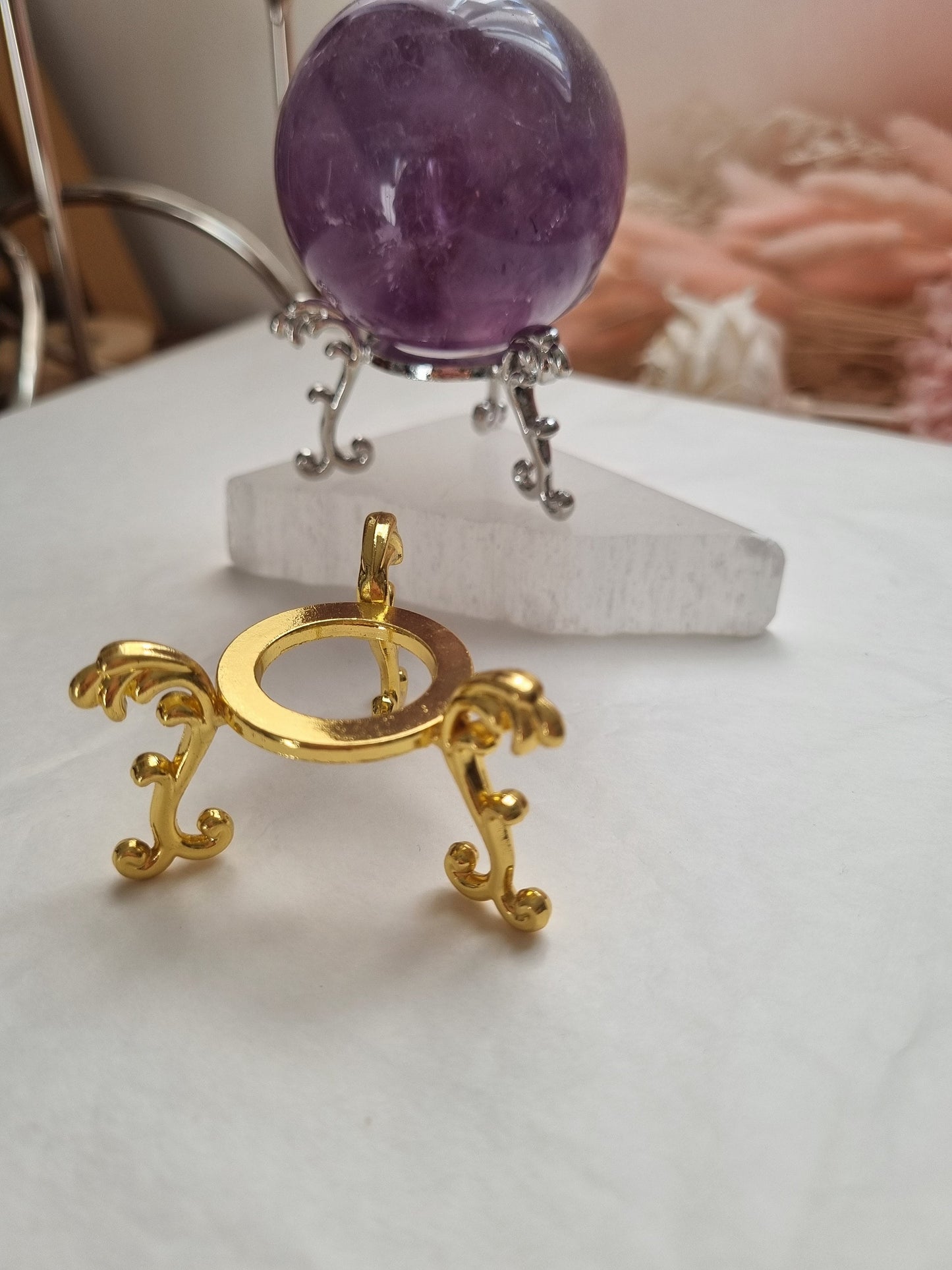 Gold and silver sphere holder
