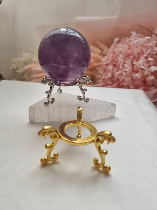 Gold and silver sphere holder